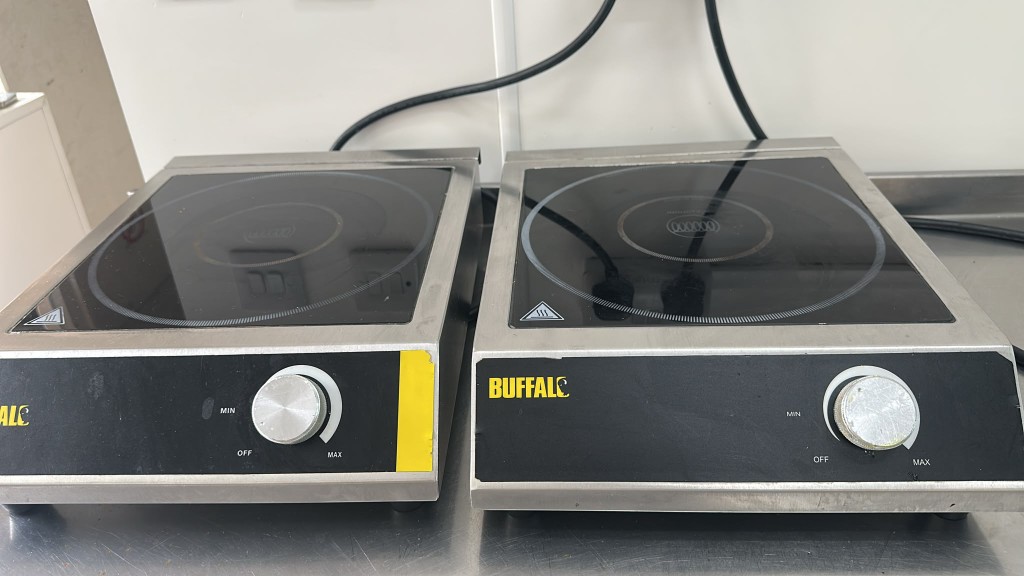 Two Buffalo portable induction hobs set to off and towards max