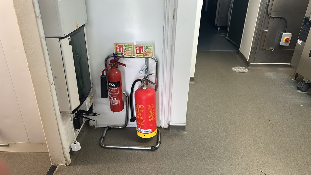 CO2 and wet chemical fire extinguishers on a stand