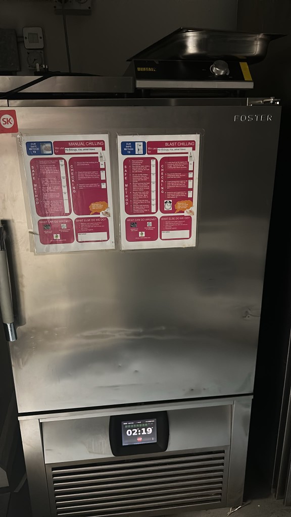 Foster blast chiller with manual and blast chilling posters on the door